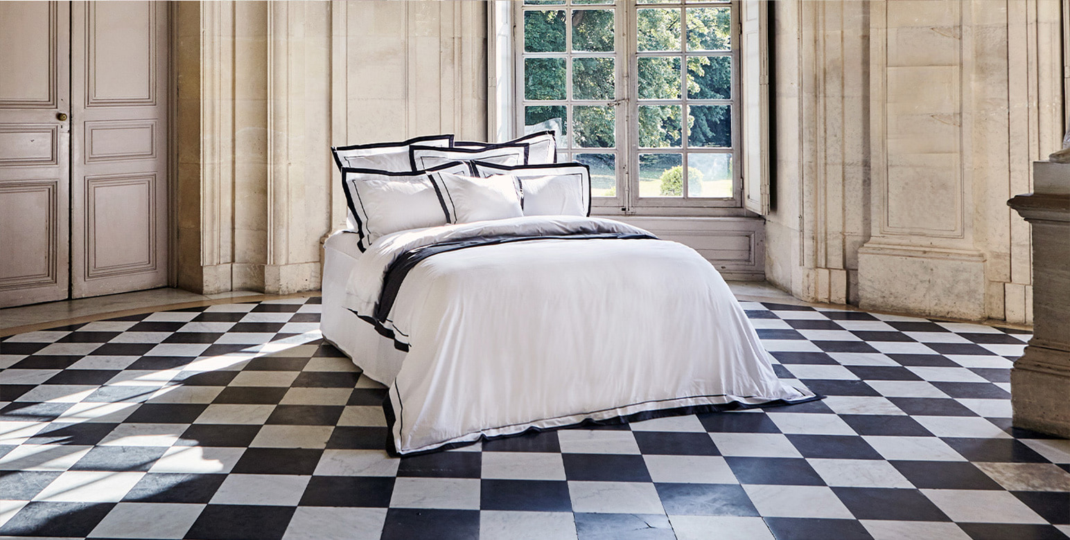 The pinnacle of luxury bedding is not merely about "softness." It is a matter of thermodynamic efficiency—specifically, how body heat, as a form of energy, is managed and preserved. At the core of Crown Goose’s high-end sleep experience lies the Science of Fill Power, analyzed here through the lens of thermal engineering.1. The Insulation of the "Still Air Layer"According to the Second Law of Thermodynamics, heat naturally migrates from a higher temperature to a lower one. The most perfect insulator to prevent the escape of human body heat into the cold external air is not gold or silver, but "Still Air."Thermal Performance of Air: The thermal conductivity of stationary air is approximately $0.024text{ W/m·K}$, among the lowest of any known substance.The Role of Fill Power: High fill power indicates that the goose down clusters occupy a larger volume, trapping a more significant number of microscopic air pockets within their structure.The Crown Goose Standard: The ultra-high fill power (over $875$) used by Crown Goose creates a massive "Air Pocket" network. This forms a formidable Thermal Barrier that fundamentally obstructs the dissipation of the body's radiant heat.2. Correlation Between Loft and Thermal Resistance (R-Value)Fill power is not simply about bulk; it is the essence of energy optimization. By providing superior "loft" (voluminousness) relative to weight, it achieves high insulation while drastically reducing the physical burden on the sleeper.$$R = frac{L}{kappa}$$(Where $R$ is thermal resistance, $L$ is the thickness of the insulation, and $kappa$ is thermal conductivity.)Optimal Density: Crown Goose down clusters possess exceptional resilience, resisting physical pressure to maintain a constant thickness ($L$).The Aesthetics of Lightness: Low fill power requires more down (weight) to achieve the same thermal resistance ($R$). In contrast, Crown Goose functions like a high-performance compression algorithm—extracting maximum thermal resistance from minimum mass. This minimizes pressure on the chest during sleep, keeping cardiopulmonary function at its peak.3. Phase Change and Entropy Management of HumidityTrue thermodynamic perfection does not end with trapping heat. During sleep, the human body releases moisture. If this moisture evaporates within the bedding, it triggers latent heat of vaporization, which can rapidly lower body temperature.Hygroscopicity and Desorption: The microscopic "barbs" of goose down absorb water vapor released during sleep and swiftly expel it to the exterior.Energy Equilibrium: If moisture remains trapped, thermal conductivity spikes, leading to a chill. Crown Goose down effectively regulates the direction of entropy (the diffusion of disordered water vapor), maintaining a constant comfort temperature ($33 pm 1^circtext{C}$) inside the duvet. It acts as a natural "Smart Thermostat."4. Conclusion: Nature’s Most Perfect Insulation AlgorithmThe fill power defined by the Science of Crown Goose is not just a sequence of numbers. It is precision thermal engineering that translates the survival instincts of geese—honed in extreme environments—into the human sleep sanctuary.$$text{Efficiency} approx text{Maximized Loft} times text{Minimized Conductivity}$$To be covered by Crown Goose is to entrust one's body to the most efficient insulation algorithm on Earth. Maintaining perfect warmth without the weight: this is The Science of Sleep pursued by Crown Goose.